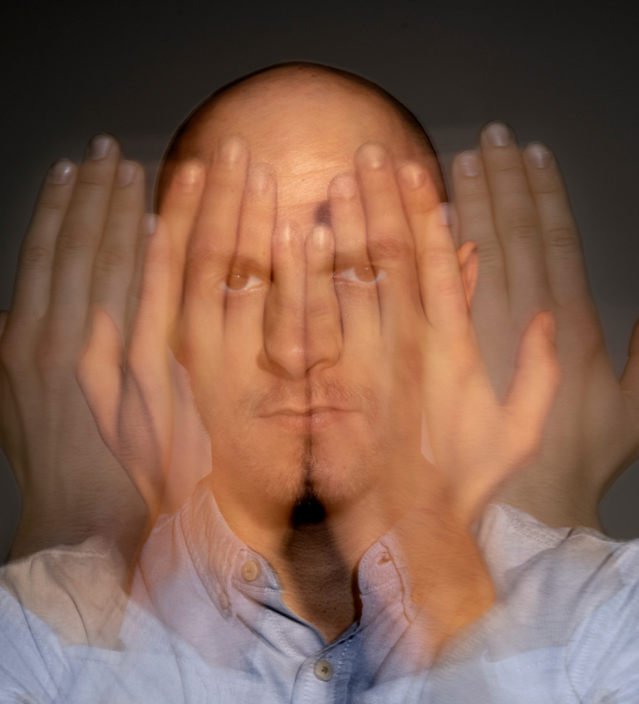 Man covering face, blurred motion effect